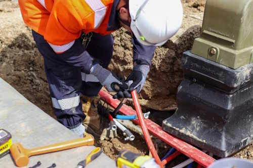 an electrician installing a distribution pillar